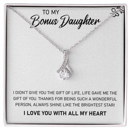 A pendant necklace in a gift box inscribed with the words "To My Bonus Daughter, Always Shine Like The Brightest Star - Alluring Beauty Necklace" by ShineOn Fulfillment.