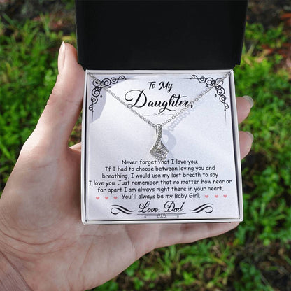 A hand holding the To My Daughter, I'm Always Right Here In Your Heart - Alluring Beauty Necklace by ShineOn Fulfillment.