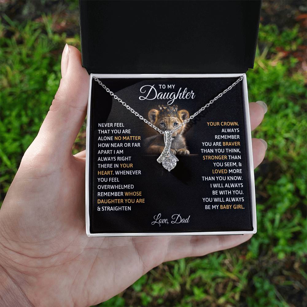 A hand holding a To My Daughter, You Will Always Be My Baby Girls - Alluring Beauty Necklace pendant with a poem by ShineOn Fulfillment.
