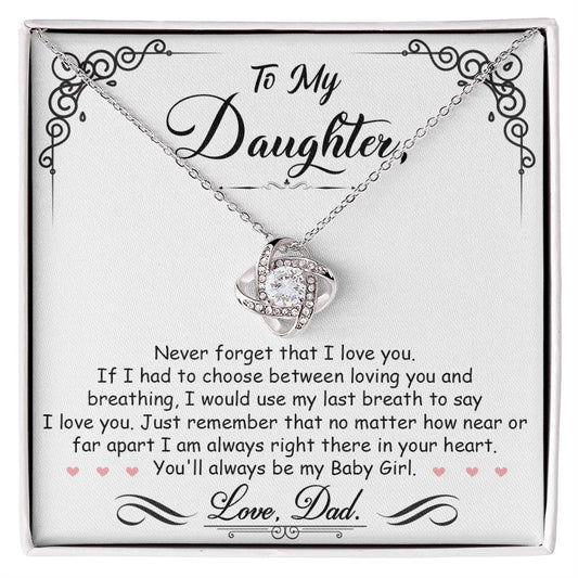 A gift box with a "To My Daughter, I'm Always Right Here In Your Heart" Love Knot Necklace pendant from ShineOn Fulfillment adorned with cubic zirconia crystals.