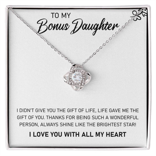 To my bonus daughter, I gifted a beautiful "To My Bonus Daughter, Always Shine Like The Brightest Star - Love Knot Necklace" from ShineOn Fulfillment. This pendant is adorned with stunning cubic zirconia crystals, making it a precious and meaningful gift.