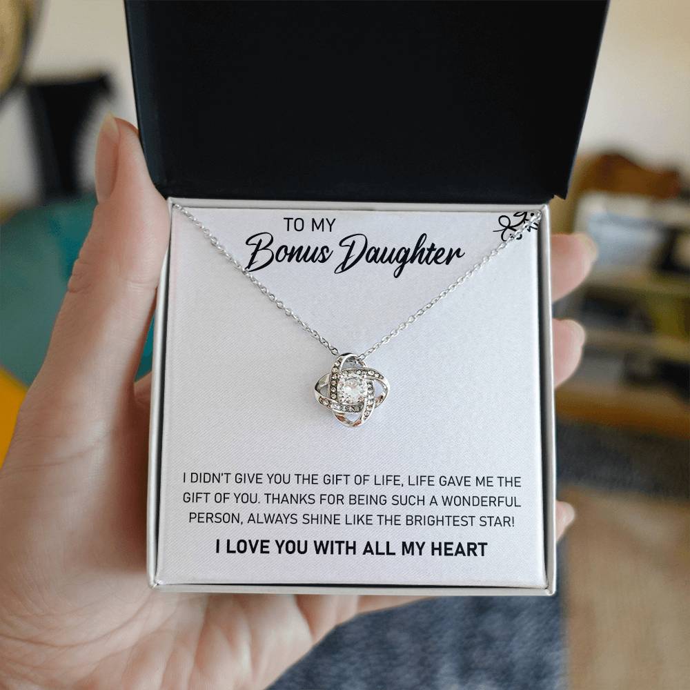 A pendant box with a To My Bonus Daughter, Always Shine Like The Brightest Star - Love Knot Necklace adorned with cubic zirconia crystals, expressing the heartfelt message "I love you with all my heart. (Brand Name: ShineOn Fulfillment)