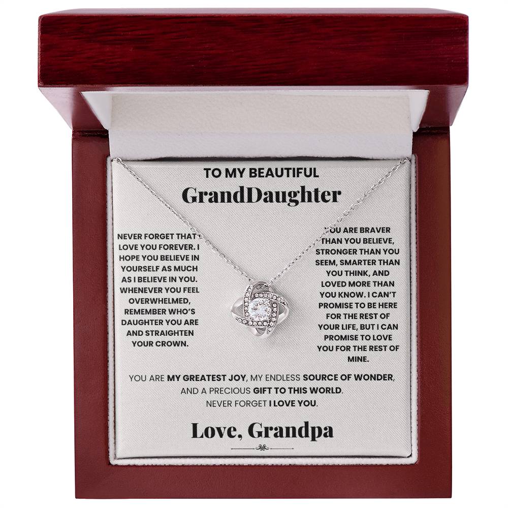 A box with a beautiful Love forever grandpa - Love Knot Necklace pendant adorned with cubic zirconia crystals, specifically designed for your granddaughter by ShineOn Fulfillment.