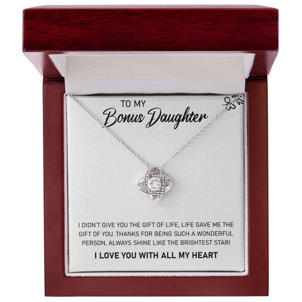 A pendant box with a "To My Bonus Daughter, Always Shine Like The Brightest Star" Love Knot Necklace adorned with cubic zirconia crystals dedicated to my beautiful daughter from ShineOn Fulfillment.