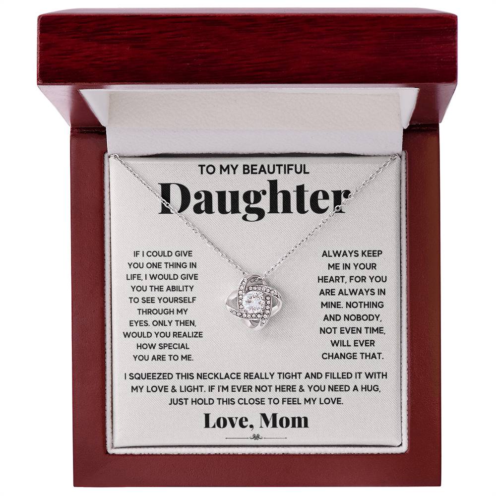 A stunning To My Beautiful Daughter, Just Hold This To Feel My Love - Love Knot Necklace gift box, featuring a beautiful cubic zirconia crystal pendant, specially engraved with the heartfelt message "to my beautiful daughter." The necklace comes with an adjustable chain length. By ShineOn Fulfillment.