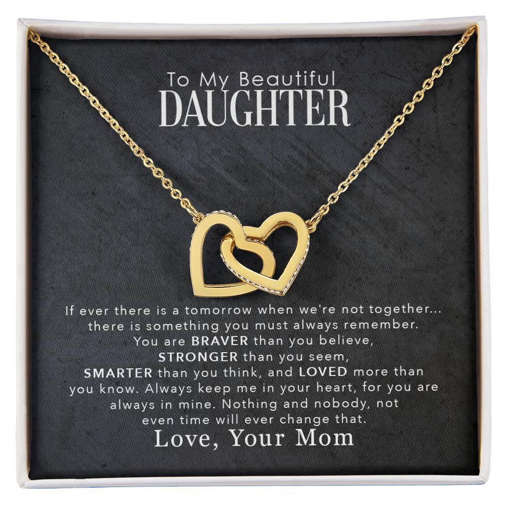 An "To My Beautiful Daughter, You Are Braver Than You Believe - Interlocking Hearts Necklace" necklace with the words to my beautiful daughter from ShineOn Fulfillment.