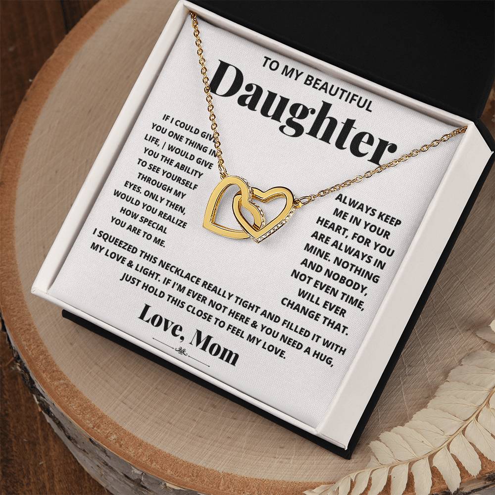 An adjustable length gift box containing an I Squeezed This Necklace Really Tight - Interlocking Hearts necklace adorned with cubic zirconia crystals, dedicated to my beautiful daughter from ShineOn Fulfillment.