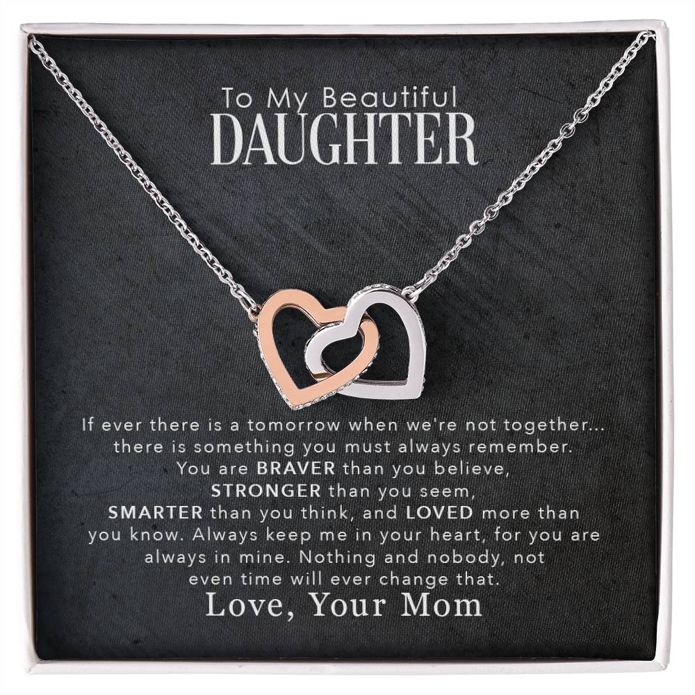 An "To My Beautiful Daughter, You Are Braver Than You Believe" Interlocking Hearts necklace adorned with cubic zirconia crystals, elegantly presented in a box by ShineOn Fulfillment.