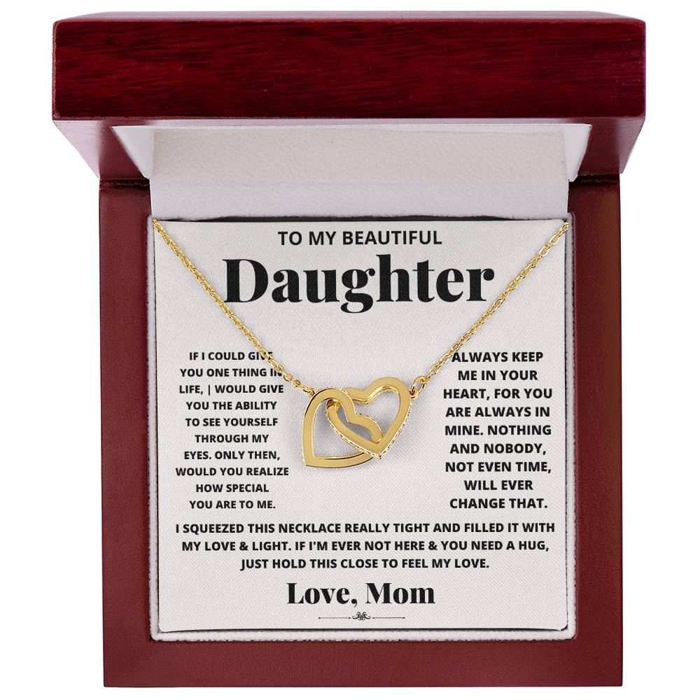 This lovely gift box contains an I Squeezed This Necklace Really Tight - Interlocking Hearts necklace with an adjustable length, adorned with cubic zirconia crystals. This heartfelt piece is engraved with "to my beautiful daughter." (Brand Name: ShineOn Fulfillment)