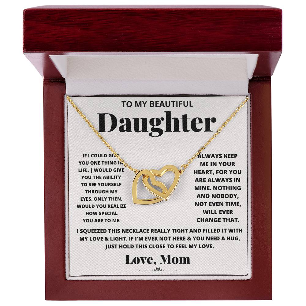 This lovely gift box contains an I Squeezed This Necklace Really Tight - Interlocking Hearts necklace with an adjustable length, adorned with cubic zirconia crystals. This heartfelt piece is engraved with "to my beautiful daughter." (Brand Name: ShineOn Fulfillment)