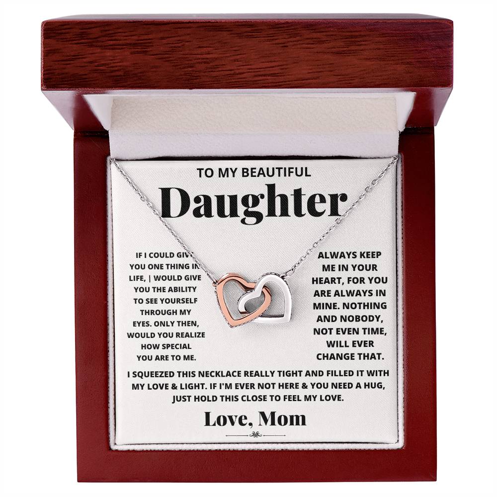 This gift box contains an I Squeezed This Necklace Really Tight - Interlocking Hearts necklace adorned with cubic zirconia crystals, featuring an adjustable length. Perfect for gifting to a beautiful daughter. (Brand Name: ShineOn Fulfillment)