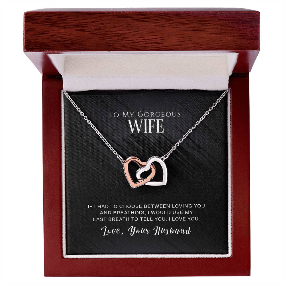Two "To My Wife, I Love You - Interlocking Hearts Necklace" necklaces adorned with cubic zirconia crystals arranged beautifully in a wooden box, perfect for gifting that special someone.