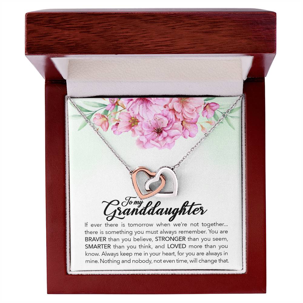 A gift box with a heart necklace and a pink flower. The "To My Granddaughter, Always Keep Me In Your Heart" Interlocking Hearts Necklace from ShineOn Fulfillment, adorned with cubic zirconia crystals, comes delicately nestled in this elegant box, alongside a charming