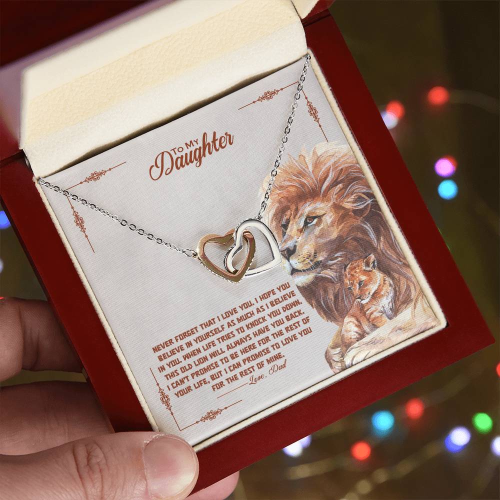 A hand holding a To My Beautiful Daughter, I Promise To Love You For The Rest Of My Life - Interlocking Hearts Necklace by ShineOn Fulfillment in a box.