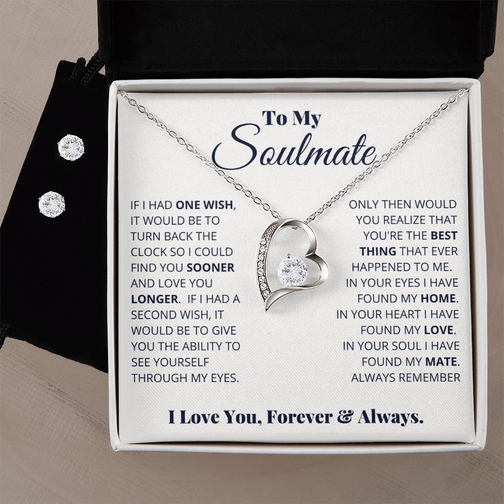 A Forever Love Necklace from ShineOn Fulfillment, featuring a heart-shaped design with diamonds and a 14k white gold finish, is beautifully presented on a card inside a gift box. The card reads "To My Soulmate" with a heartfelt message. Alongside the necklace is an elegantly paired Cubic Zirconia Earring Set, completing the sentimental surprise.