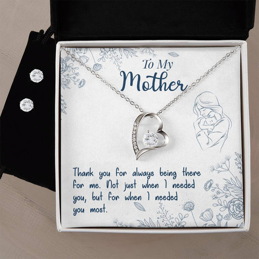The "To My Mother, Thank You For Always Being There - Forever Love Necklace" by ShineOn Fulfillment elegantly features a silver heart-shaped pendant with a 14k white gold finish, embellished with a small gemstone. It comes beautifully presented in a white box adorned with floral patterns. The backdrop carries the heartfelt message "To My Mother," alongside a sincere thank you note, and includes an elegant Cubic Zirconia Earring Set.