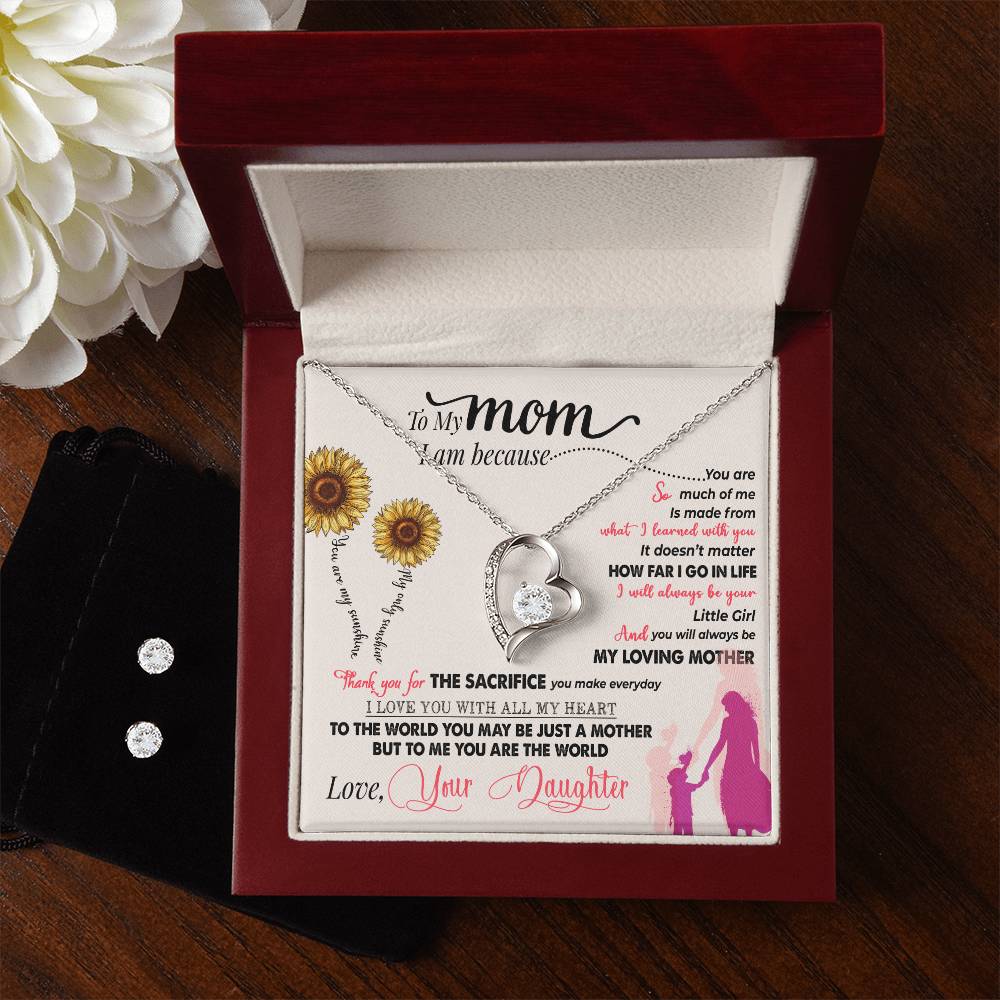 An open jewelry box showcases a heartfelt letter to "Mom," highlighting the Forever Love Necklace, complete with intertwined rings and a crystal pendant, from ShineOn Fulfillment's To My Mom, Thank You For Everything collection. Sunflower graphics enhance the presentation alongside a sparkling Cubic Zirconia Earring Set in a sleek black pouch.