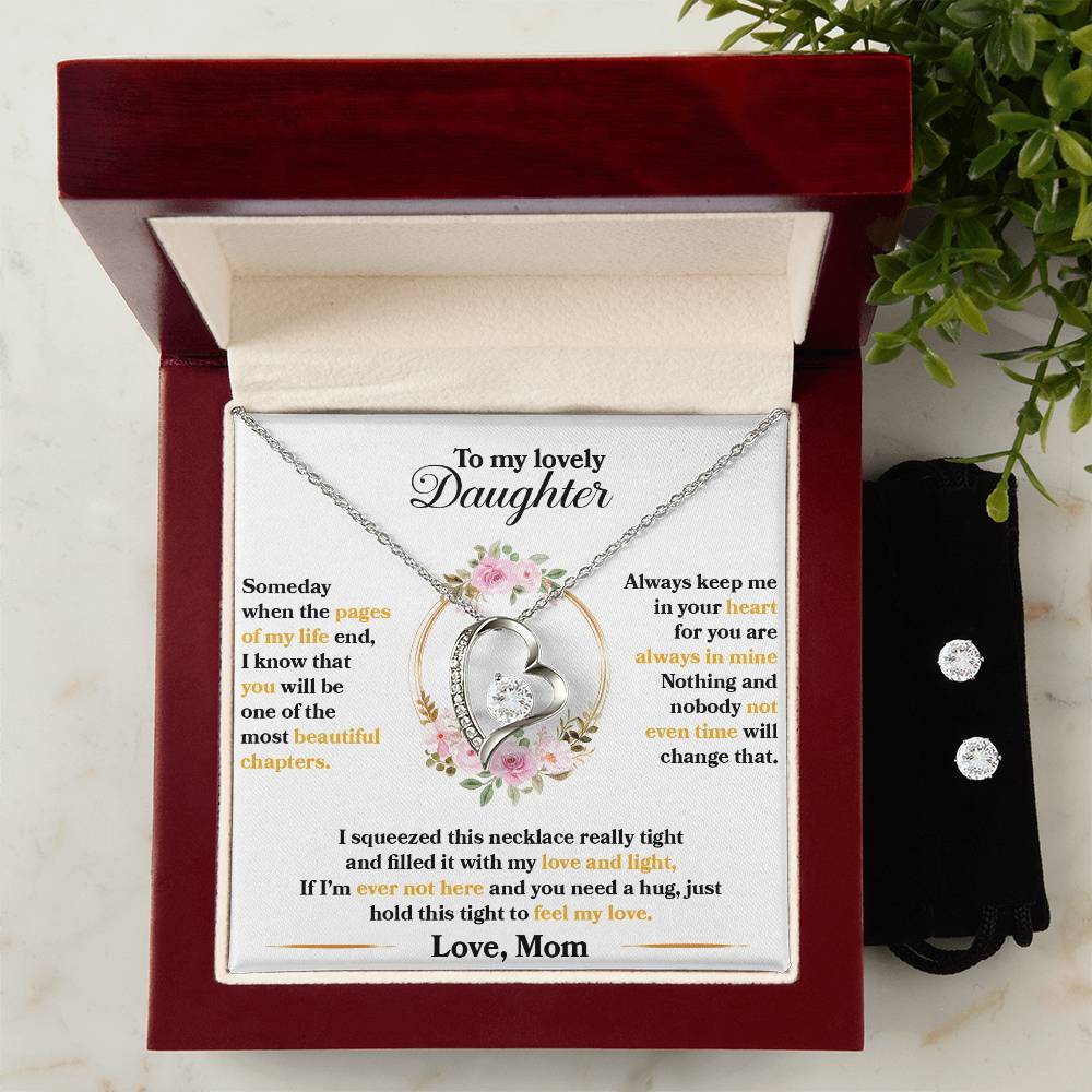 The "To My Lovely Daughter, Hold This Tight To Feel My Love - Forever Love Necklace" by ShineOn Fulfillment is elegantly presented in a jewelry gift box. It showcases two interlocking heart-shaped pendants adorned with a small diamond and is crafted with a 14k white gold finish. Accompanying the necklace is a heartfelt message from a mother to her daughter, surrounded by an exquisite floral border design.