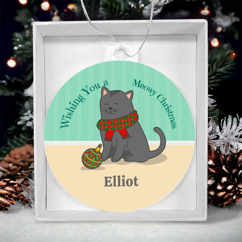 The Celebrate Your Furry Friend with a Personalized Cat Name Christmas Ornament by AnywherePOD is a high-quality acrylic ornament featuring an adorable gray cat wearing a red and green scarf next to a decorated bauble. The text reads: "Wishing You a Meowy Christmas" and "Elliot." This personalized ornament is ideal for your holiday collection, set against a festive green background with a subtle pattern.