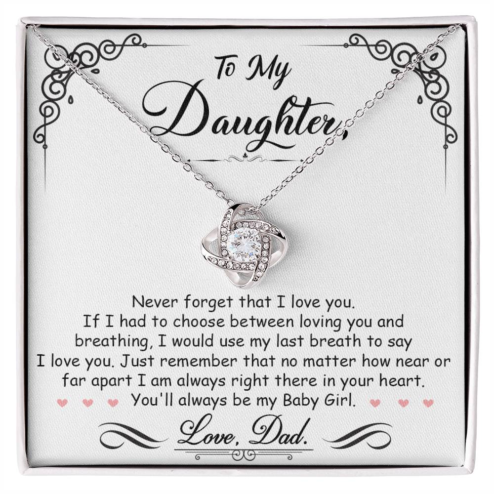 A gift box with a "To My Daughter, I'm Always Right Here In Your Heart" Love Knot Necklace pendant from ShineOn Fulfillment adorned with cubic zirconia crystals.