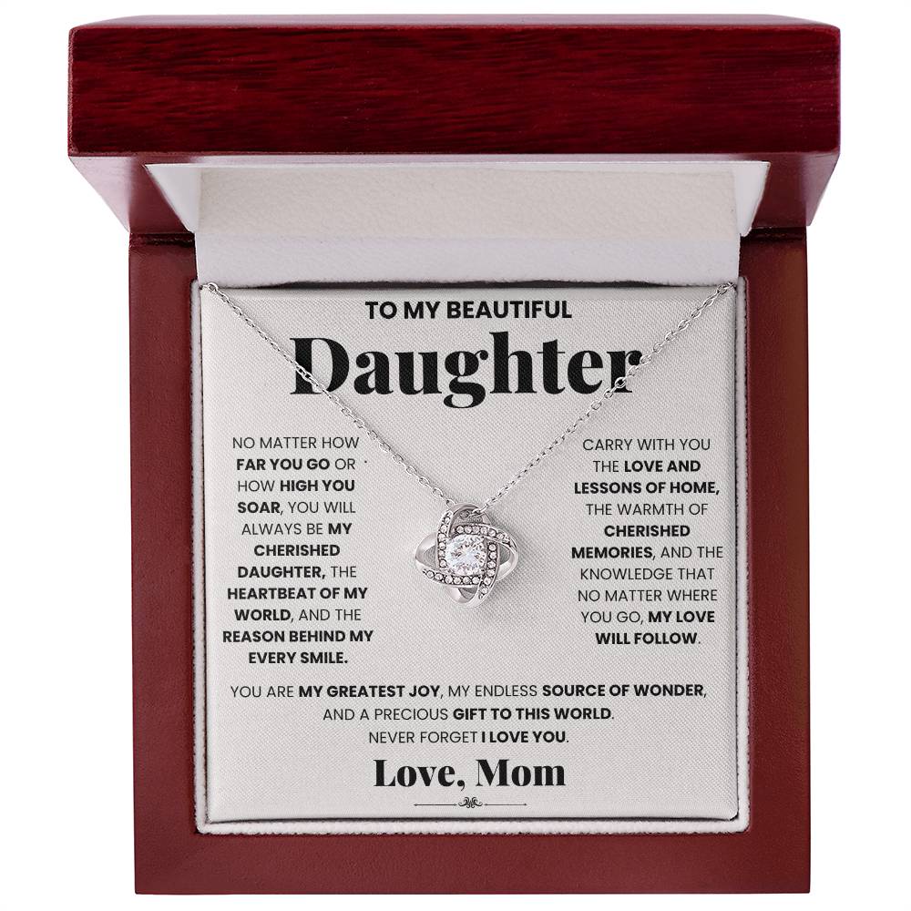 A gift box with the My Cherished Daughter - Love Knot Necklace, symbolizing an unbreakable bond between a mother and her daughter by ShineOn Fulfillment.
