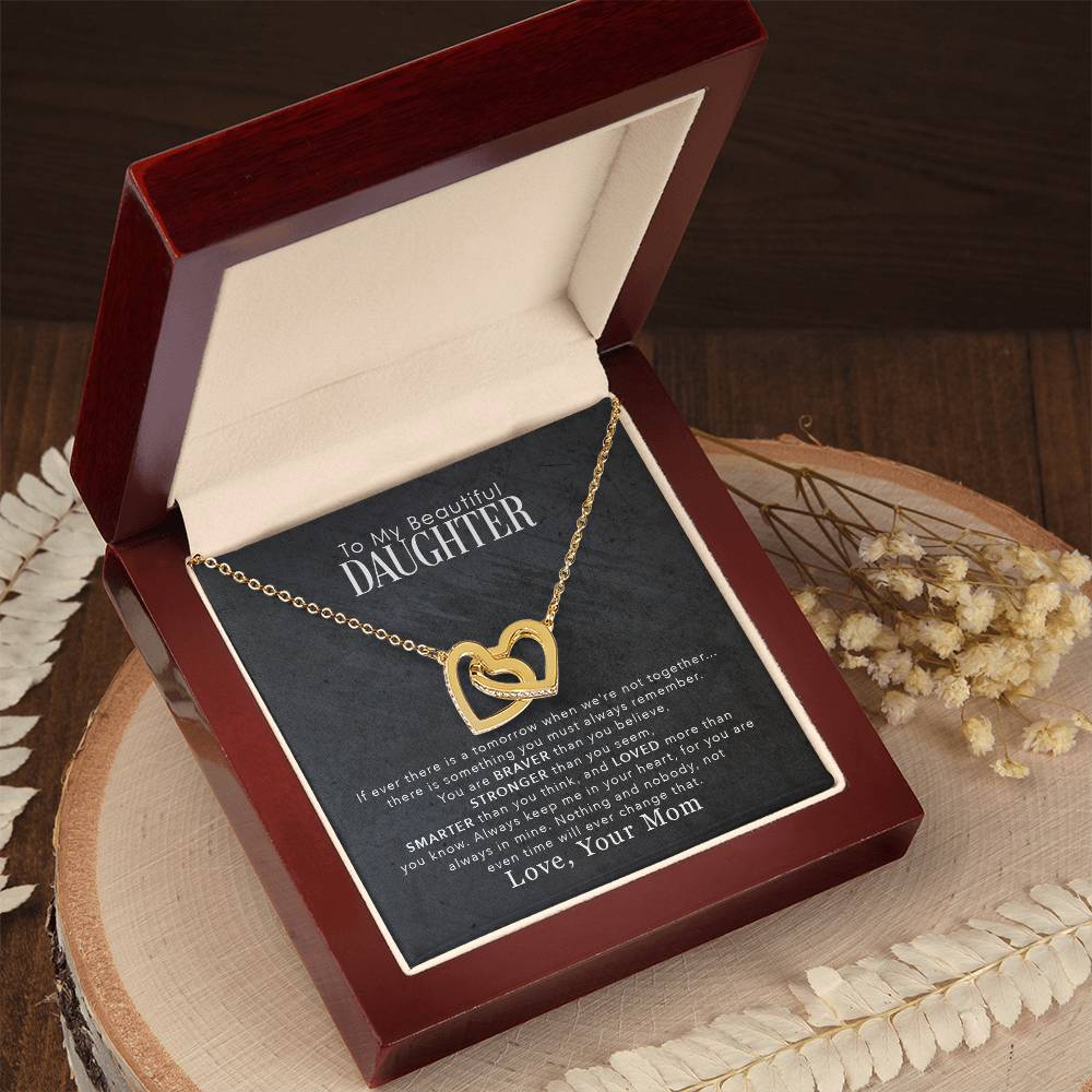 A gift box with a "To My Beautiful Daughter, You Are Braver Than You Believe - Interlocking Hearts Necklace" by ShineOn Fulfillment, adorned with cubic zirconia crystals.