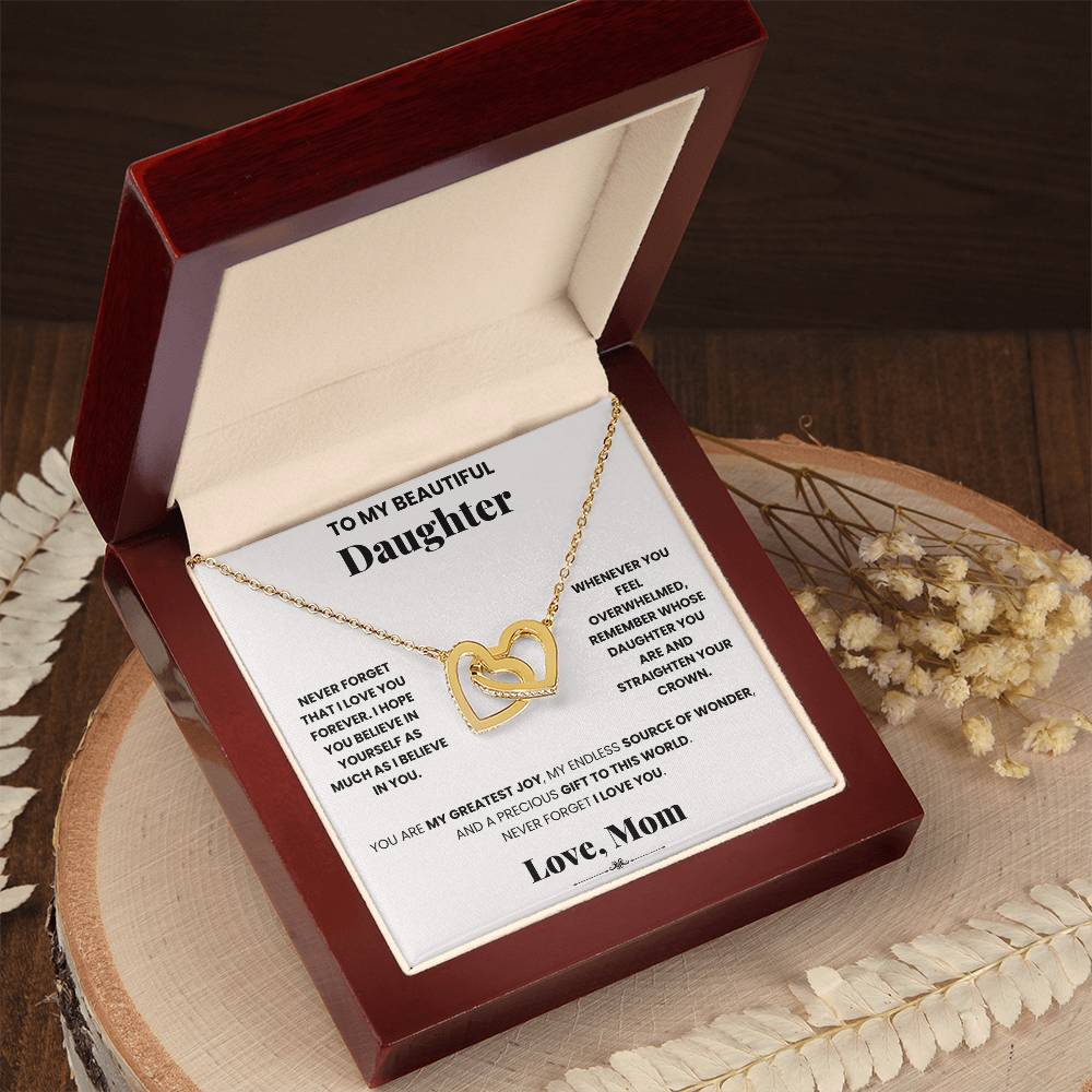 A ShineOn Fulfillment gift box with a Love Forever - Interlocking Hearts Mom - Interlocking Hearts Necklace adorned with hearts and sparkling cubic zirconia crystals.