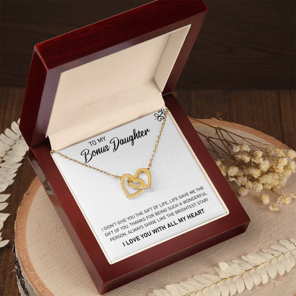 A To My Bonus Daughter, Always Shine Like The Brightest Star - Interlocking Hearts Necklace enclosed in a charming wooden box, making it an ideal gift by ShineOn Fulfillment.