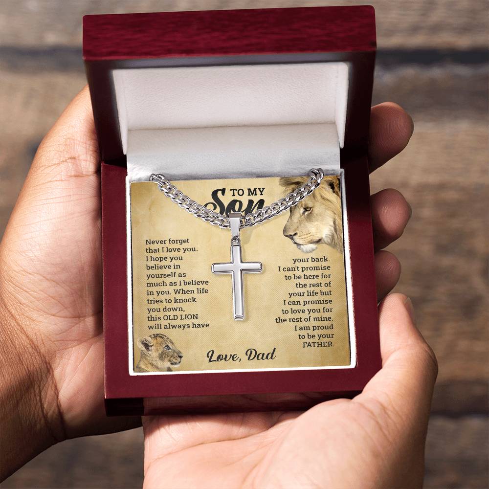 A person lovingly holds the "To My Son - This Old Lion Has Your Back" necklace, cherishing the heartfelt poem engraved upon it by ShineOn Fulfillment.