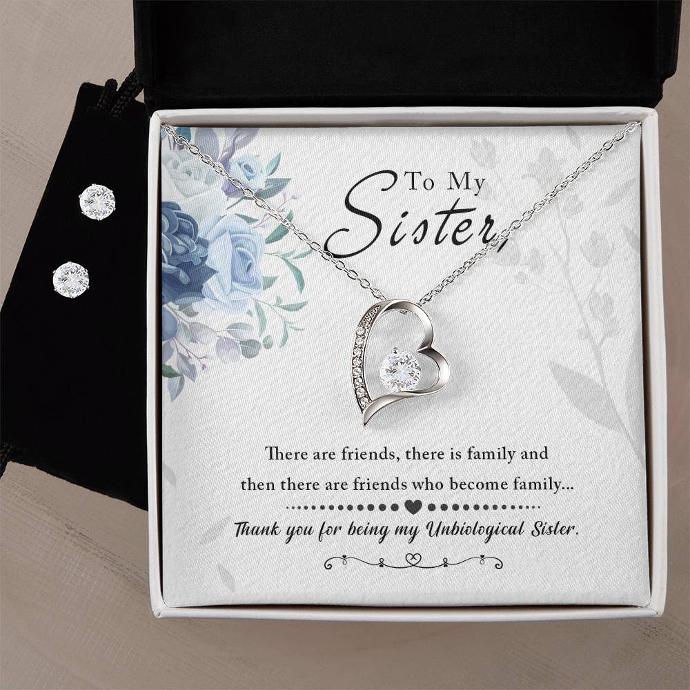 Presented in an elegant open jewelry box, the "To My Sister, Thank You For Everything - Forever Love Necklace" by ShineOn Fulfillment showcases a heart-shaped pendant adorned with a small gem and boasts a breathtaking 14k white gold finish. It is paired with a matching Cubic Zirconia Earring Set. The box includes a message card reading "To My Sister," enhanced with beautiful floral designs.