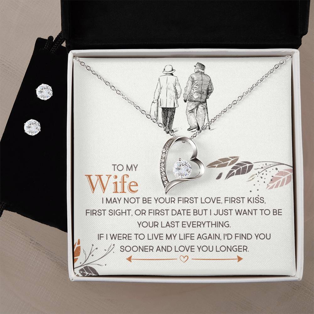 A necklace and earring set from ShineOn Fulfillment, called "To My Wife, I Just Want To Be Your Last Everything - Forever Love," features a heart-shaped pendant adorned with a diamond. Presented in a jewelry box illustrated with an elderly couple and the words "To my Wife," the set symbolizes eternal love with its 14k white gold finish.