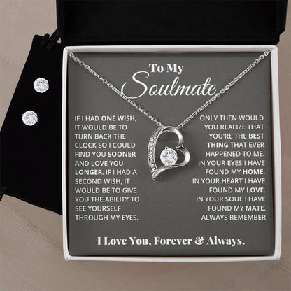 The "To My Soulmate, In Your Heart I Found My Love - Forever Love Necklace" by ShineOn Fulfillment features a 14k white gold finish with a heart-shaped pendant adorned with a diamond, elegantly suspended on a chain. It is beautifully displayed against a backdrop of an emotional message to your soulmate, while the gray box is accented with two small diamonds beside the necklace.