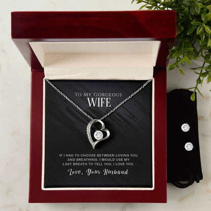 The "To My Wife, I Love You - Forever Love Necklace" by ShineOn Fulfillment showcases a heart-shaped pendant adorned with a central jewel, beautifully presented in an open red and white box. The message inside reads: "To my gorgeous wife, if I had to choose between loving you and breathing, I would use my last breath to tell you I love you. Love, your husband.