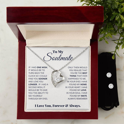 A heart-shaped Forever Love Necklace with a diamond, from ShineOn Fulfillment's "To My Soulmate, I Love You, Forever & Always" collection, is showcased in an open red box. Its 14k white gold finish adds elegance to the piece. The box lid displays a heartfelt message for a soulmate. Next to it rests a black pouch containing the Cubic Zirconia Earring Set, completing this stunning gift ensemble.