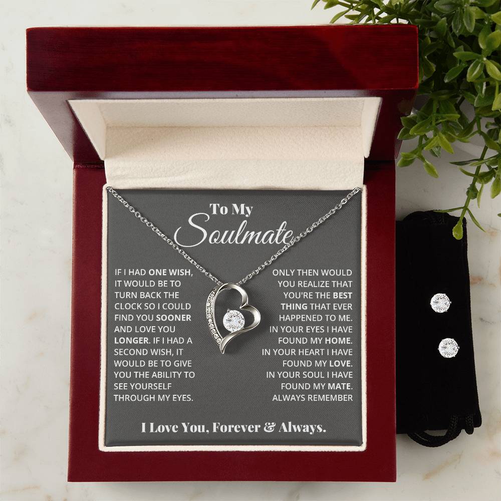 Displayed in an open jewelry box is the "To My Soulmate, In Your Heart I Found My Love - Forever Love Necklace" by ShineOn Fulfillment, featuring a heart-shaped pendant with a 14k white gold finish. Inside the lid is a heartfelt message about love and destiny addressed to a soulmate. Beside the box rests a Cubic Zirconia Earring Set, tucked neatly in a small black pouch.