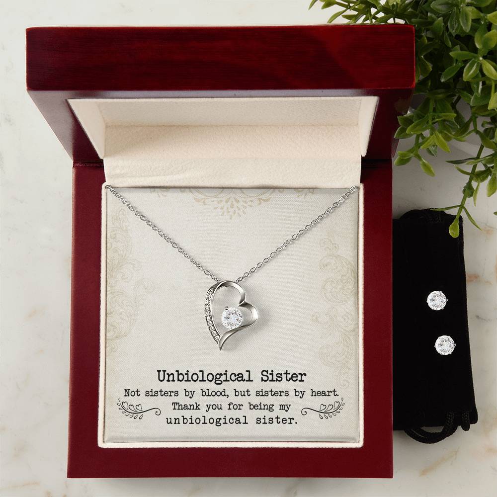 The Forever Love Necklace, featuring a heart pendant adorned with a gem and beautifully crafted with a 14k white gold finish, is presented inside a red gift box that says: "Unbiological Sister." Alongside it lies an exquisite Cubic Zirconia Earring Set. Thank you for being my sister by heart. 

Product: To My Unbiological Sister, Sister By Heart - Forever Love Necklace  
Brand: ShineOn Fulfillment