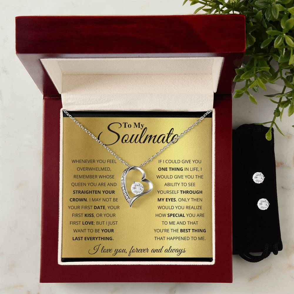 A beautifully presented gift box opens to reveal the "To My Soulmate, You're The Best Thing That Happened To Me - Forever Love Necklace" by ShineOn Fulfillment. This exquisite piece features a heart design adorned with a clear gemstone, set in an elegant 14k white gold finish. Accompanying it is a golden card inscribed with a heartfelt message, and nearby, a small pouch holds the matching Cubic Zirconia Earring Set, perfectly completing this timeless expression of love.