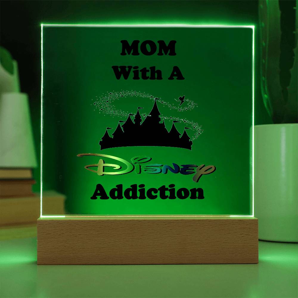 The Disney-Obsessed Mom: Where Magic Meets Motherhood! plaque by ShineOn Fulfillment serves as a luminous decorative lamp, featuring the phrase "Mom With A Disney Addiction" on a castle silhouette. Its wooden base highlights the captivating green glow, making it an ideal piece for any mom who dreams of the enchantment of the Magic Kingdom.